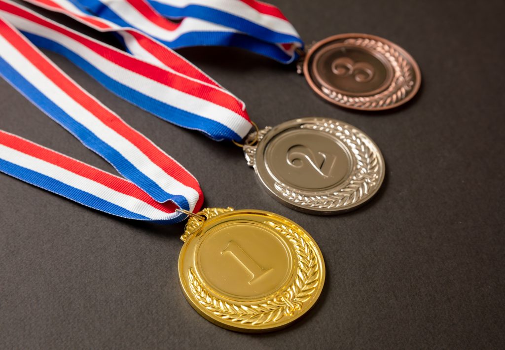 Gold, silver and bronze medals set on black background. Sports athletes winners prize